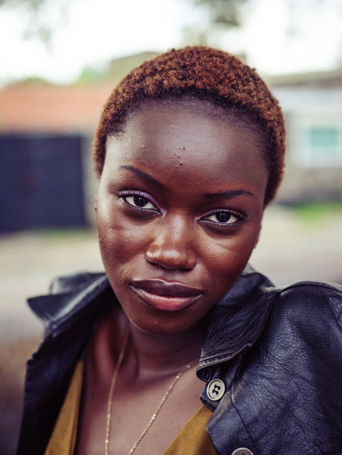 A beautiful black woman gazes directly at the camera
